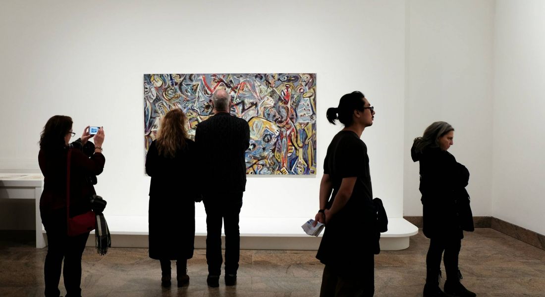 Art enthusiasts viewing an exhibit at a gallery near Wheatfield Village.