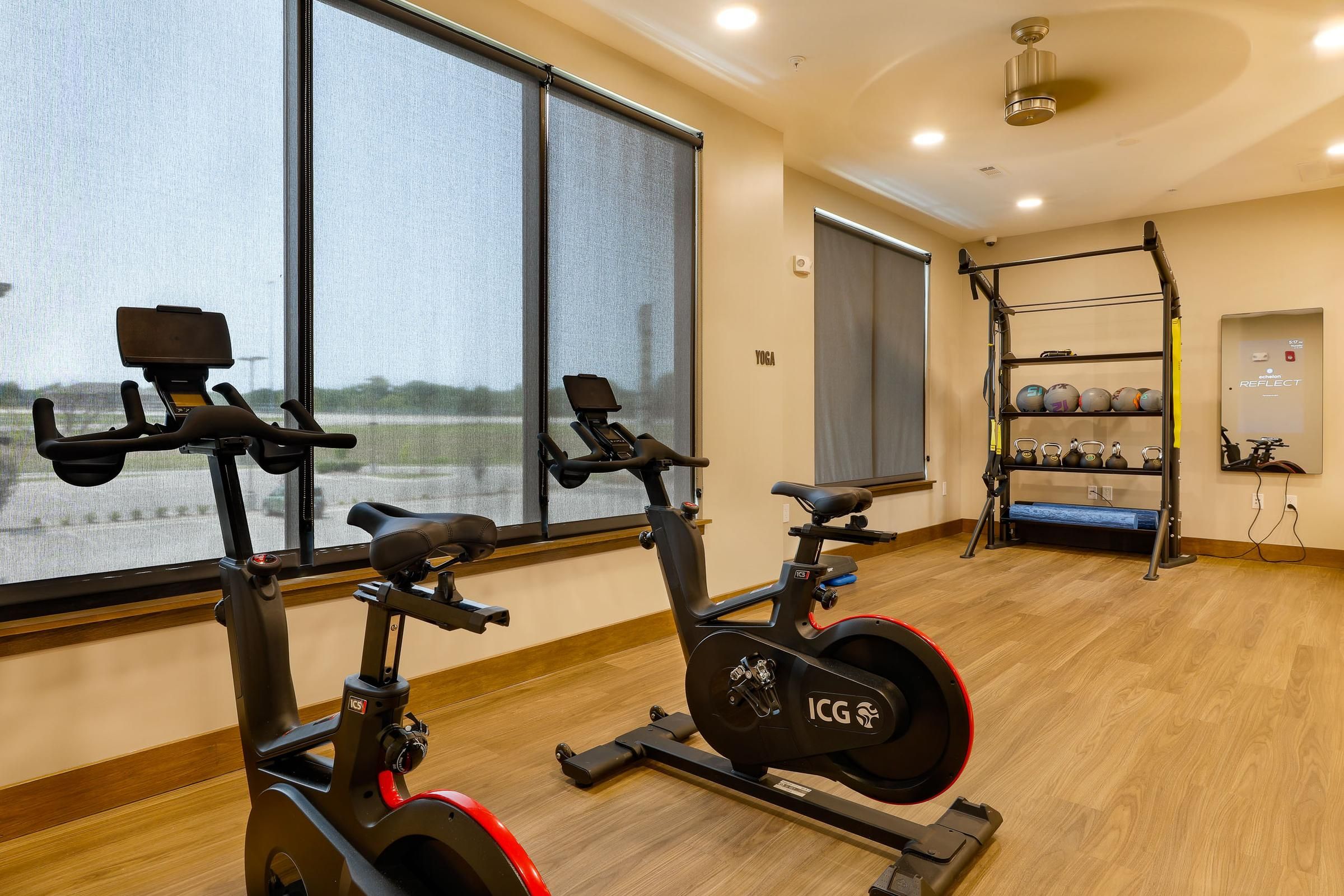 Indoor cycling room at Wheatfield Village with exercise bikes and strength training equipment.