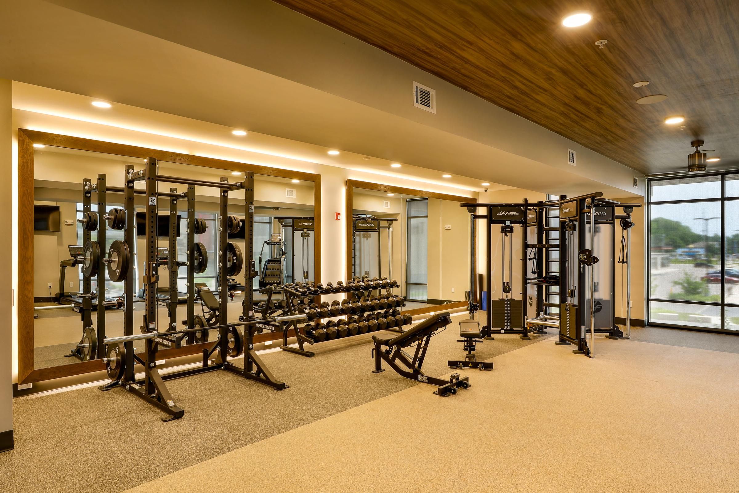 Well-equipped fitness center at Wheatfield Village with various workout machines.